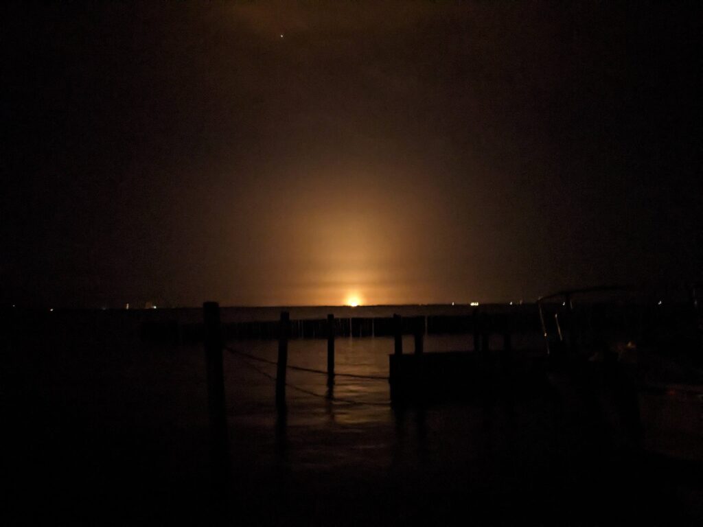 A night time rocket launch at Kennedy Space Center as seen from Titusville, FL